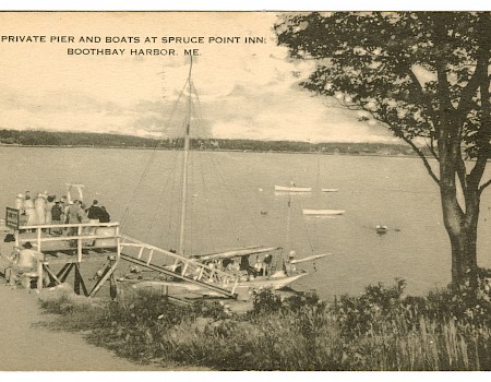A vintage postcard shows a private pier with boats at Spruce Point Inn, Boothbay Harbor, ME, with people gathered near the dock.